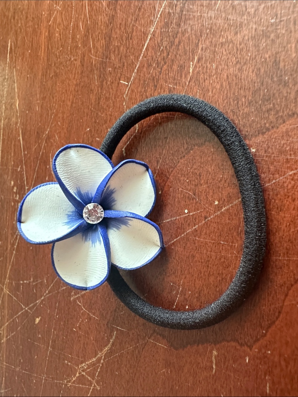 Black Elastic Hair Tie with White and Blue Flower Accent